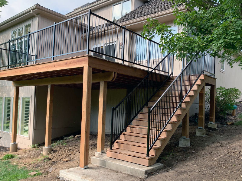 Custom exterior residential deck and iron railing creation.